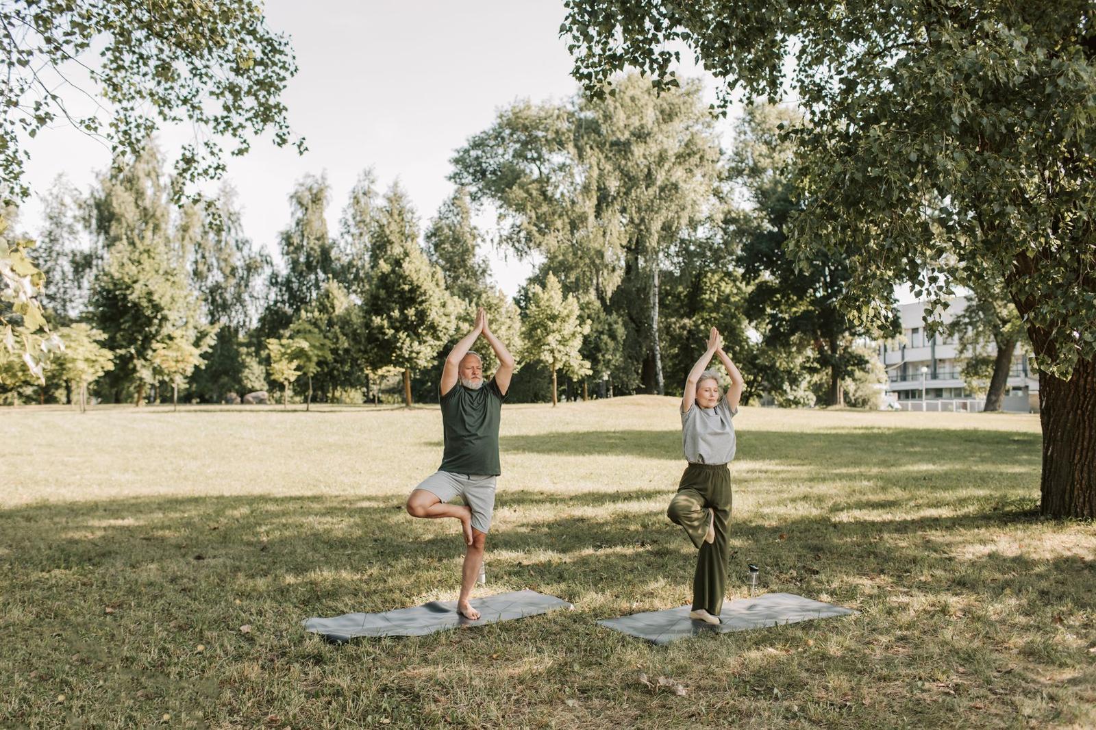 An Elderly Couple Doing Yoga at the Park
